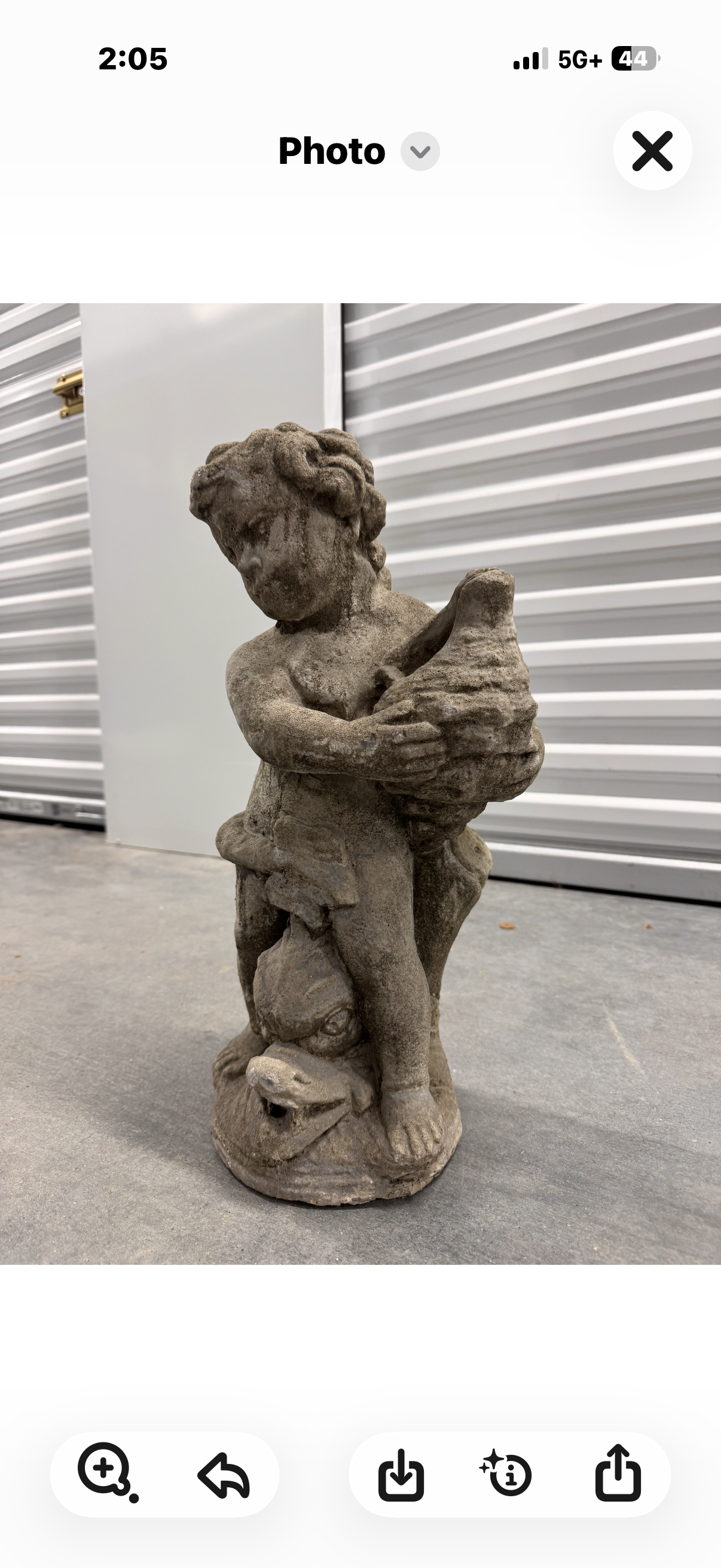 Little boy worth shell statue
